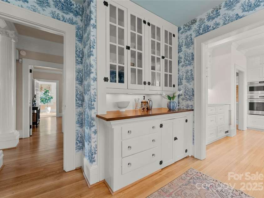 215 Main Street, Belmont, NC 28012.  MLS# CAR4134774, YatesRealty ID 22545. The original built-in side board has lots of storage with a new solid wood top, under cabinet lighting and is perfect for a breakfast bar.  It features operable glass doors with original wavy glass and hardware.