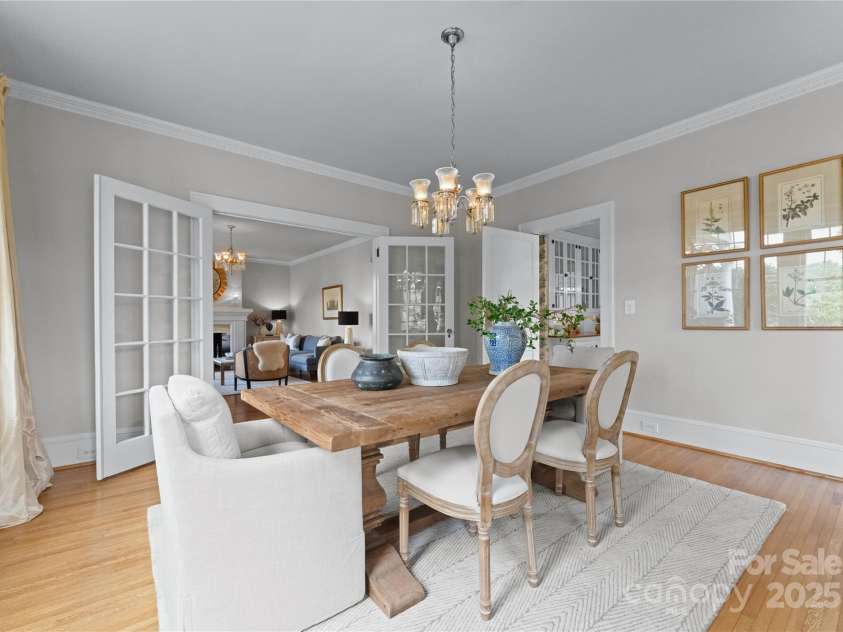 215 Main Street, Belmont, NC 28012.  MLS# CAR4134774, YatesRealty ID 22545. The spacious Dining room is just off the Living room and features original oak flooring plus a swing privacy door that leads to the cozy Breakfast room.  Rear wall is mirrored enhancing the light in the already sunny space!