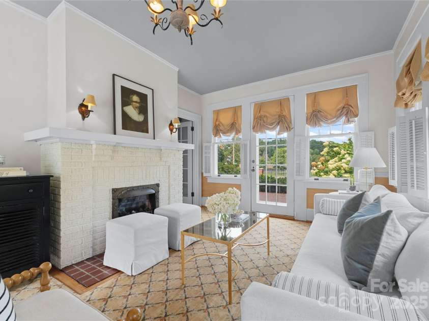 215 Main Street, Belmont, NC 28012.  MLS# CAR4134774, YatesRealty ID 22545. The Sunroom has view from one side of mature landscaping making it private and original wavy glass windows.  Seamless storm windows cover the original windows.  Great access to the pool terrace is perfect for entertaining!