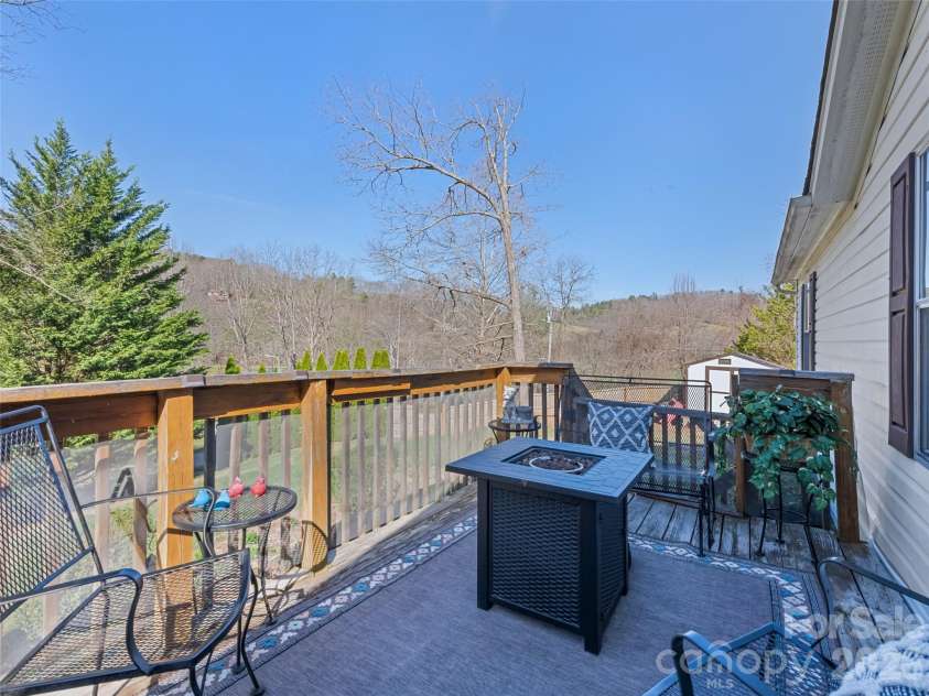 136 Peaceful Valley Drive, Leicester, NC 28748.  MLS# CAR4378331, YatesRealty ID 22556. Relax on the front deck