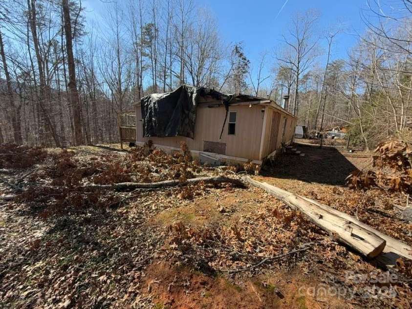 127 Round Top Road, Mill Spring, NC 28756.  MLS# CAR4217273, YatesRealty ID 2256. Tree came down onto home during Hurricane Helene.