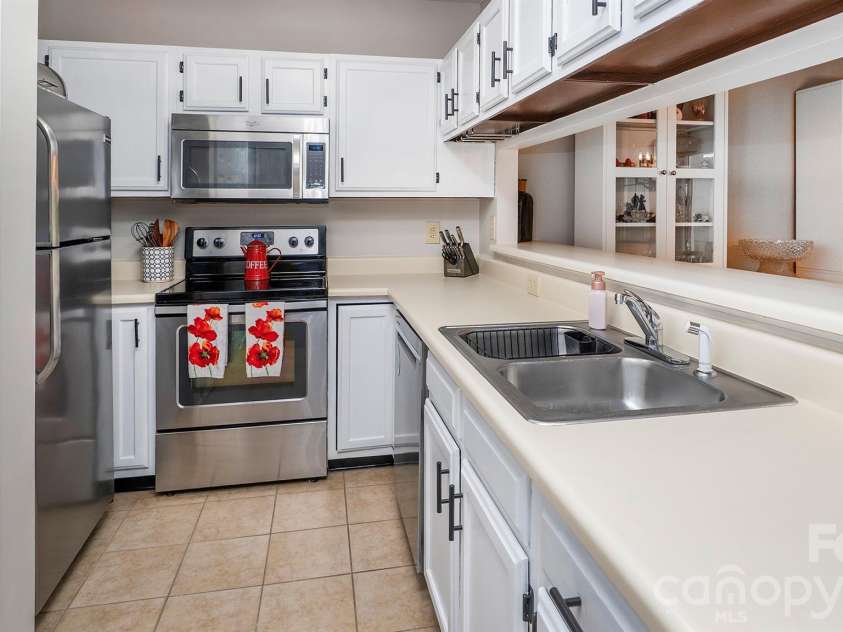 19823 Henderson Road, Cornelius, NC 28031.  MLS# CAR4374380, YatesRealty ID 22560. Double sink with great counter space and washer/dryer closet...