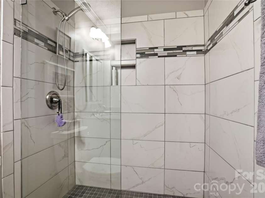 19823 Henderson Road, Cornelius, NC 28031.  MLS# CAR4377209, YatesRealty ID 22560. Primary has tiled shower with glass doors
