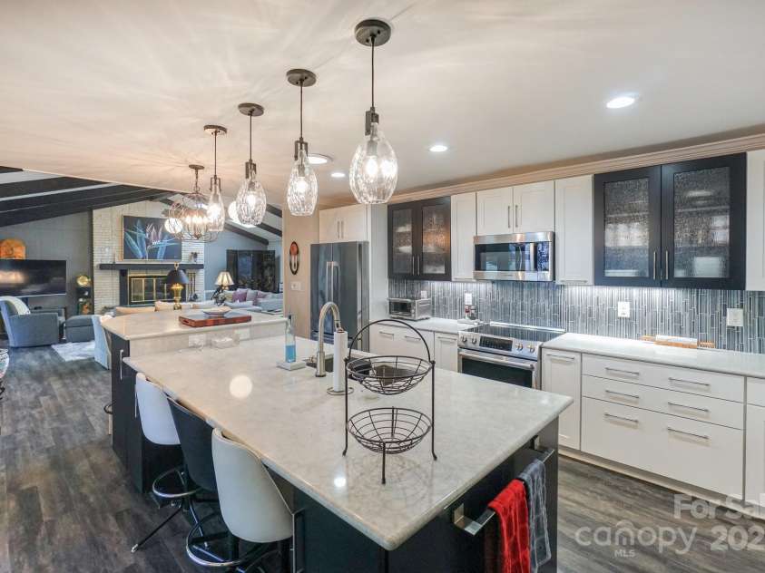 7945 Placid Court, Denver, NC 28037.  MLS# CAR4269290, YatesRealty ID 22561. Custom cabinetry with pull out drawers, new appliances and lighting, and an added bar height sitting area attached to the oversized island.