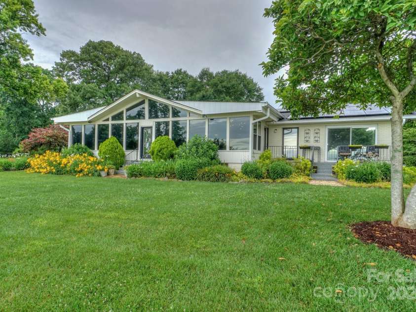 7945 Placid Court, Denver, NC 28037.  MLS# CAR4269290, YatesRealty ID 22561. Enjoy morning coffee from the Updated Primary Suite waterfront porch.