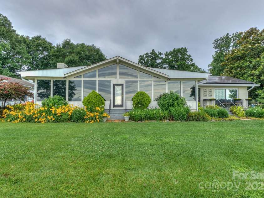 7945 Placid Court, Denver, NC 28037.  MLS# CAR4269290, YatesRealty ID 22561. Great Waterfront views from the full back of the home sunroom, kitchen, and primary bedroom.