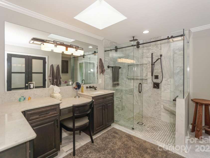 7945 Placid Court, Denver, NC 28037.  MLS# CAR4269290, YatesRealty ID 22561. Primary ensuite bath has been completely remodeled with new cabinetry, walk in tiled shower with glass surround,  and tiled flooring.