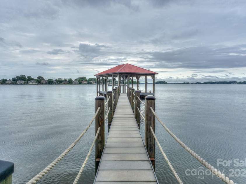 7945 Placid Court, Denver, NC 28037.  MLS# CAR4269290, YatesRealty ID 22561. Private and upgraded covered dock w/ boatlift and pier