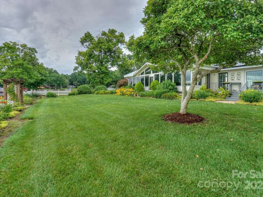 7945 Placid Court, Denver, NC 28037.  MLS# CAR4269290, YatesRealty ID 22561. Side yard view showing depth of yard.