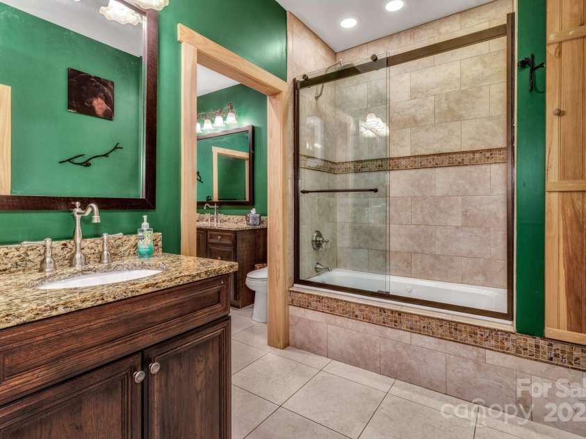 432 Atlantic Falls Trail, Black Mountain, NC 28711.  MLS# CAR4206241, YatesRealty ID 2257. Connected shared bathroom on the lower level between a family room and the lower level guest suite.