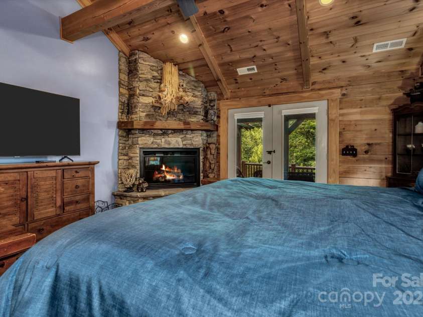 432 Atlantic Falls Trail, Black Mountain, NC 28711.  MLS# CAR4206241, YatesRealty ID 2257. Primary bedroom also has french doors out to a covered porch with another gas log fire place.