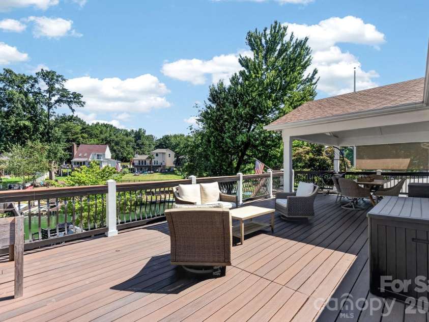 21200 Rio Oro Drive, Cornelius, NC 28031.  MLS# CAR4396261, YatesRealty ID 22574. Spectacular oversized upper deck entertaining with water views.