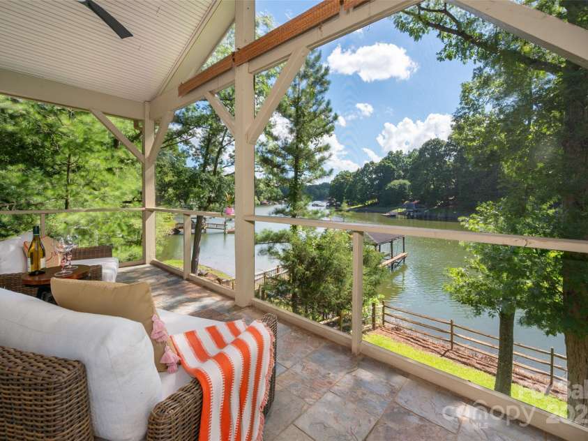 6259 River Cabin Lane, Charlotte, NC 28278.  MLS# CAR4271955, YatesRealty ID 22576. Enjoy seamless indoor-outdoor living with a screened porch right off the primary bedroom—your own relaxing escape!