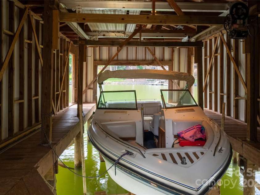 6259 River Cabin Lane, Charlotte, NC 28278.  MLS# CAR4271955, YatesRealty ID 22576. Interior of boathouse- equipped with a boat lift and opening to the floating dock.
