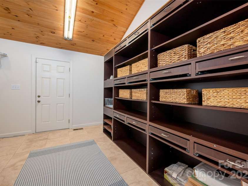 6259 River Cabin Lane, Charlotte, NC 28278.  MLS# CAR4271955, YatesRealty ID 22576. Spacious primary closet featuring custom cabinetry and a convenient washer/dryer hookup.