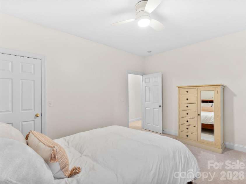 36 White Ash Drive, Asheville, NC 28803.  MLS# CAR4310417, YatesRealty ID 22580. Upper level bedroom features plush carpeting and closet, offering comfort and functionality.