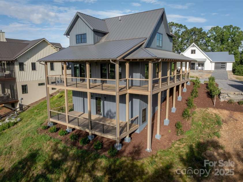 231 Westridge Farm Drive, Asheville, NC 28804.  MLS# CAR4265956, YatesRealty ID 22588. Backside of house with two levels of porches.