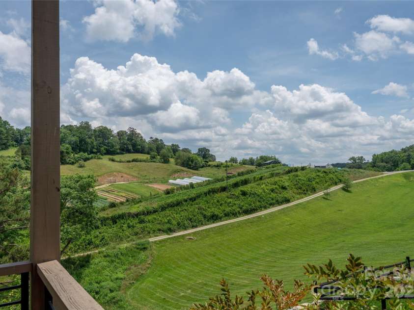 231 Westridge Farm Drive, Asheville, NC 28804.  MLS# CAR4265956, YatesRealty ID 22588. Porch with farm view and green pasture