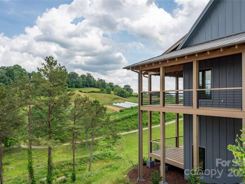 231 Westridge Farm Drive, Asheville, NC 28804.  MLS# CAR4265956, YatesRealty ID 22588. Wrap Around Porch with Farm View
