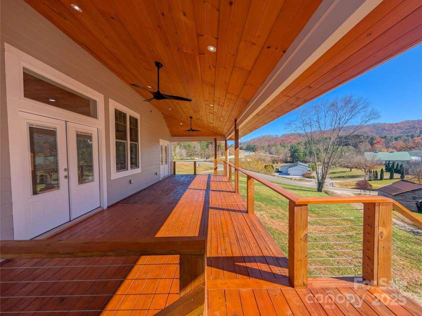 7854 US Highway 19E None, Burnsville, NC 28714.  MLS# CAR4319007, YatesRealty ID 2260. Additional view of back covered porch featuring tongue & groove ceilings, recessed lighting, outdoor ceiling fans, access to living area & beautiful pastoral mountain views!