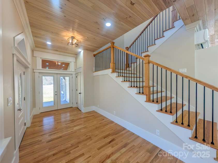 7854 US Highway 19E None, Burnsville, NC 28714.  MLS# CAR4319007, YatesRealty ID 2260. Entry foyer has additional access to covered front porch, half bath & staircase leading to second floor. Tongue & groove ceilings with recessed lighting. Wi-Fi Smart Switches with dimmers throughout home.