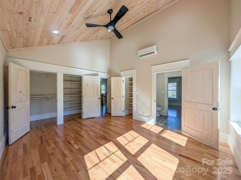 7854 US Highway 19E None, Burnsville, NC 28714.  MLS# CAR4319007, YatesRealty ID 2260. First bedroom to right offers vaulted tongue & groove ceiling, recessed lighting, ceiling fan, large insulated pela windows showcasing mountain views, closet with built-in shelving, large walk-in closet and access