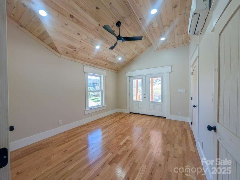 7854 US Highway 19E None, Burnsville, NC 28714.  MLS# CAR4319007, YatesRealty ID 2260. First Ensuite features architectural tongue & groove ceiling design with recessed lighting, ceiling fan, walk-in closet & full bathroom with access to covered back porch and mountain views through windows!