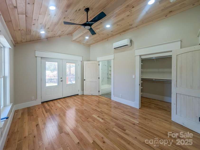 7854 US Highway 19E None, Burnsville, NC 28714.  MLS# CAR4319007, YatesRealty ID 2260. First Ensuite features architectural tongue & groove ceiling design with recessed lighting, ceiling fan, energy efficient mini-split, walk-in closet & full bathroom with access to covered back porch and mountain v
