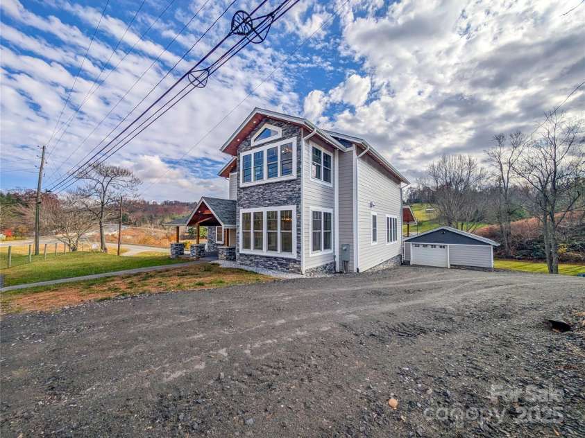 7854 US Highway 19E None, Burnsville, NC 28714.  MLS# CAR4319007, YatesRealty ID 2260. Gravel driveway continues around side of home and connects to Hemlock Rd providing additional access options to property.