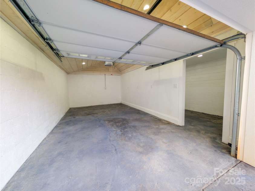 7854 US Highway 19E None, Burnsville, NC 28714.  MLS# CAR4319007, YatesRealty ID 2260. Interior of One Car Garage that has been updated & remodeled with tongue & groove ceiling, recessed lighting and additional storage area. 