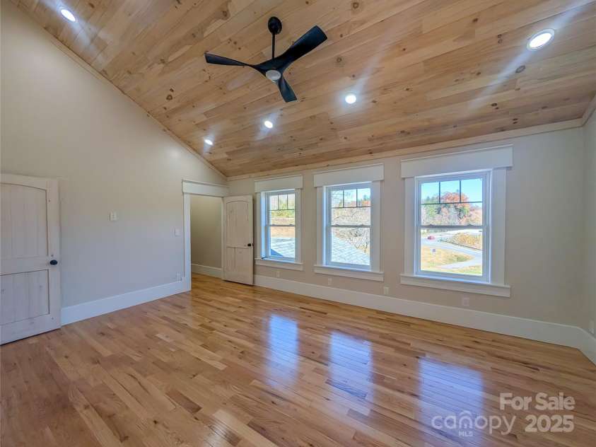 7854 US Highway 19E None, Burnsville, NC 28714.  MLS# CAR4319007, YatesRealty ID 2260. Second bedroom to right offers vaulted tongue & groove ceiling, recessed lighting, ceiling fan, large insulated pela windows showcasing mountain views, closet with built-in shelving, additional attic storage, larg