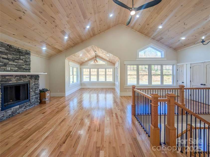 7854 US Highway 19E None, Burnsville, NC 28714.  MLS# CAR4319007, YatesRealty ID 2260. Second floor features open concept great room with stone fireplace, tongue & groove vaulted ceiling, recessed lighting, ceiling fan, second laundry room & closet with built-in shelving. This space offers flexibili