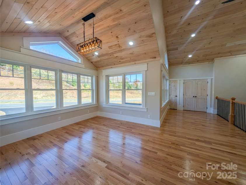 7854 US Highway 19E None, Burnsville, NC 28714.  MLS# CAR4319007, YatesRealty ID 2260. Second floor features open concept great room with stone fireplace, tongue & groove vaulted ceiling, recessed lighting, ceiling fan, second laundry room & closet with built-in shelving. This space offers flexibili