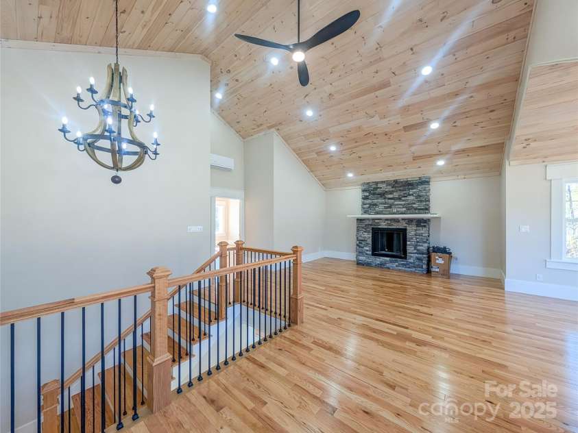7854 US Highway 19E None, Burnsville, NC 28714.  MLS# CAR4319007, YatesRealty ID 2260. Second floor features open concept great room with stone fireplace, tongue & groove vaulted ceiling, recessed lighting, ceiling fan, second laundry room & closet with built-in shelving. This space offers flexibili