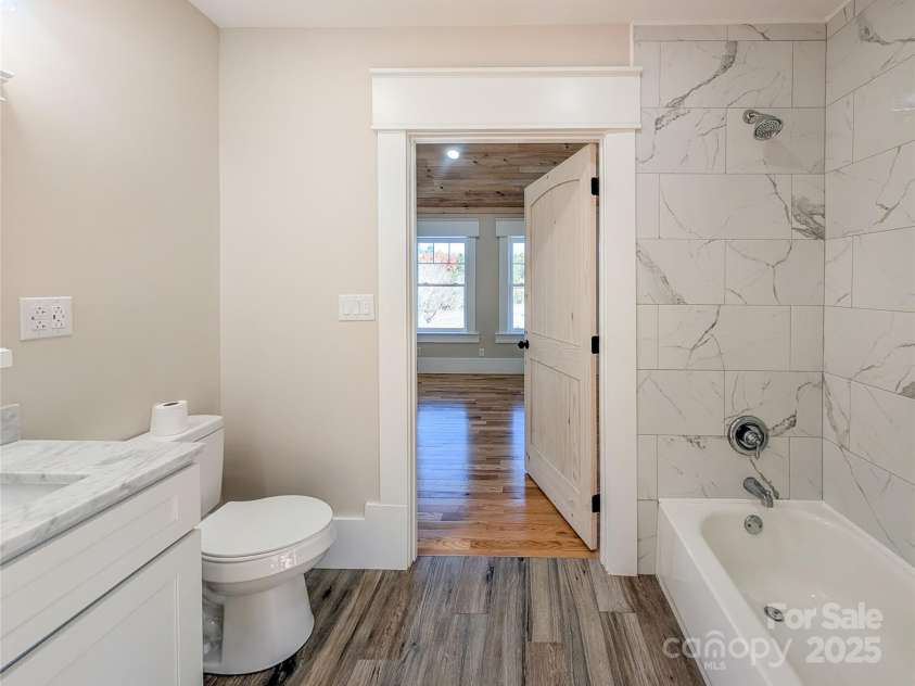 7854 US Highway 19E None, Burnsville, NC 28714.  MLS# CAR4319007, YatesRealty ID 2260. Shared dual access full bathroom features heated tile floors with wi-fi thermostats