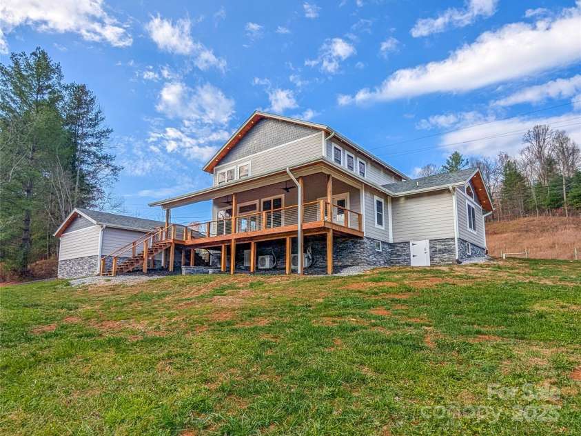 7854 US Highway 19E None, Burnsville, NC 28714.  MLS# CAR4319007, YatesRealty ID 2260. View from back yard of home & garage. Crawl space access is below covered porch. 