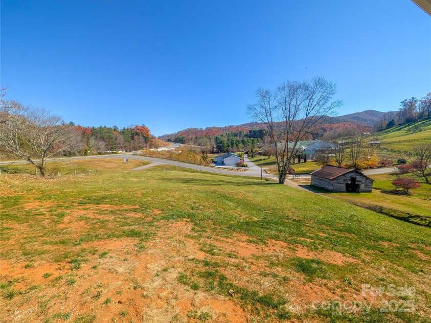 7854 US Highway 19E None, Burnsville, NC 28714.  MLS# CAR4319007, YatesRealty ID 2260. View of yard to side of property and additional lot that is available to purchase separately from owner. 