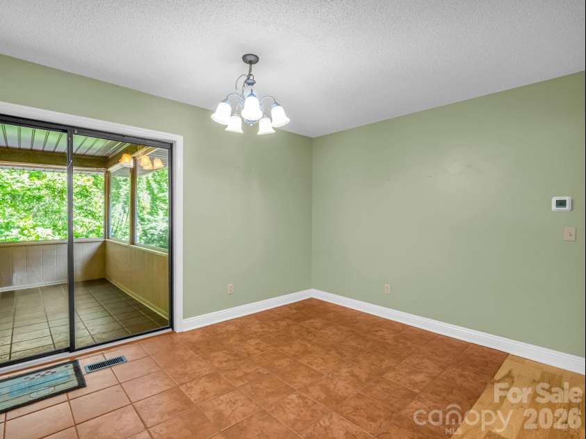 156 Deer Run, Hendersonville, NC 28739.  MLS# CAR4397683, YatesRealty ID 22616. Dining Area with Screened Porch Access