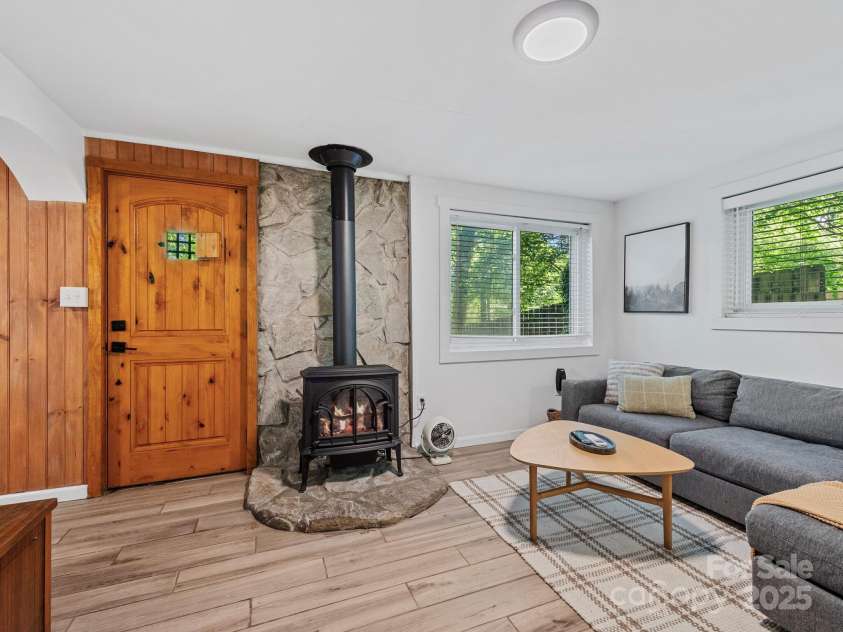 24 Iroquois Street, Black Mountain, NC 28711.  MLS# CAR4251240, YatesRealty ID 22645. Lower Level Family Room w/Wood Stove