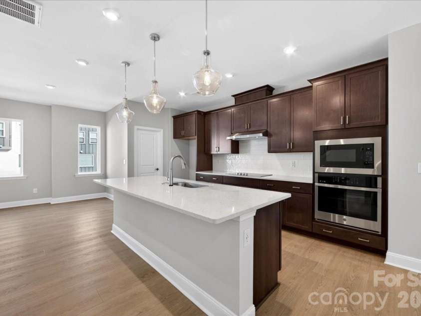 7933 Cedarsmith Court, Charlotte, NC 28217.  MLS# CAR4367732, YatesRealty ID 22647. Gourmet Kitchen with dark brown cabinets