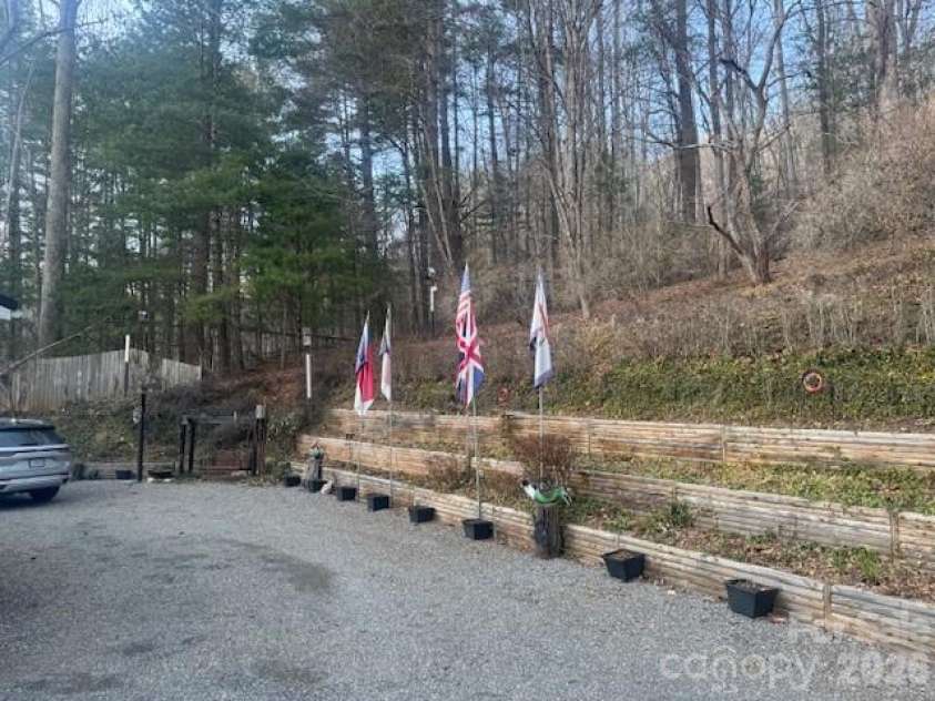 1372 Lickskillet Road, Burnsville, NC 28714.  MLS# CAR4333089, YatesRealty ID 2265. Back of house with landscaping beds