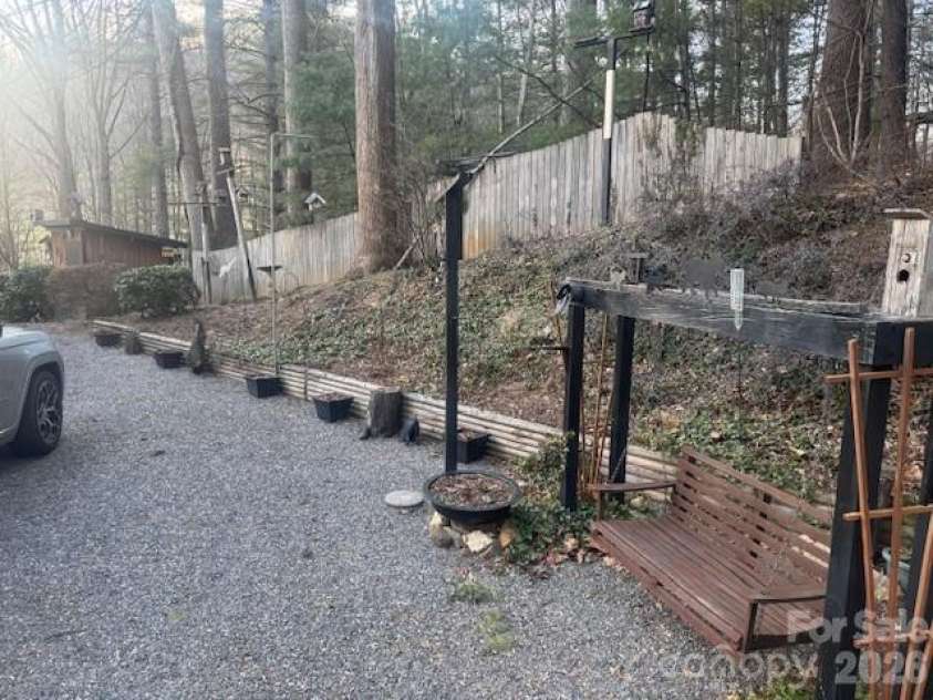 1372 Lickskillet Road, Burnsville, NC 28714.  MLS# CAR4333089, YatesRealty ID 2265. Back of property with the porch swing