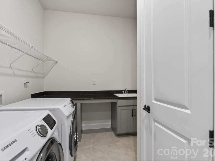 1405 Encore Lane, Waxhaw, NC 28173.  MLS# CAR4366207, YatesRealty ID 22650. Laundry Room with Folding Table