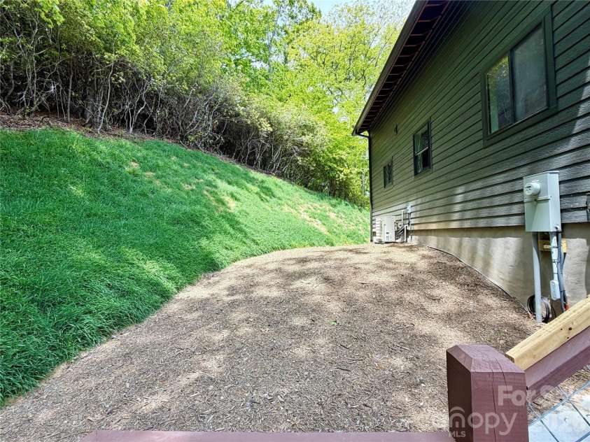 114 Phivo Drive, Balsam Grove, NC 28708.  MLS# CAR4319518, YatesRealty ID 22663. Side Yard!
