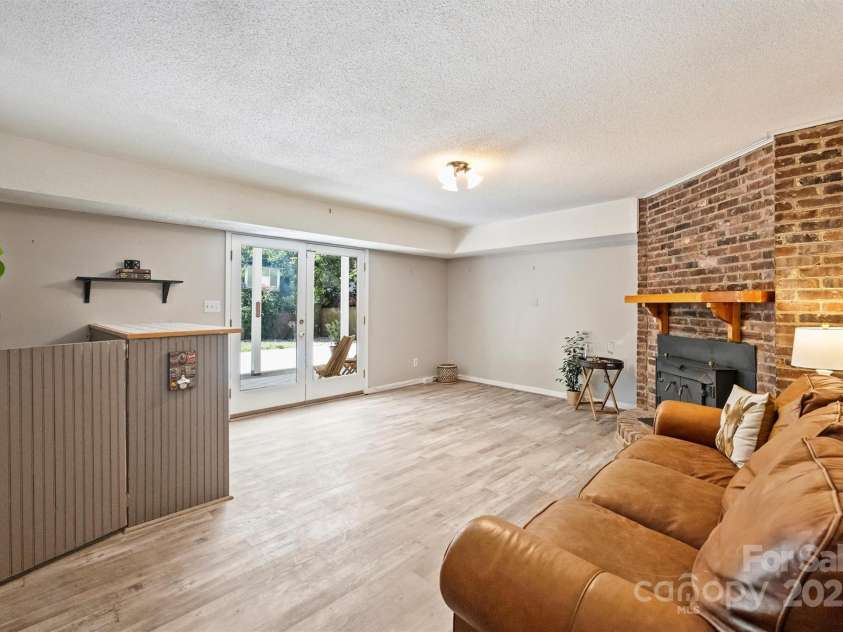 6150 Rocky Falls Road, Charlotte, NC 28211.  MLS# CAR4270630, YatesRealty ID 22677. Downstairs, an expansive basement provides additional living space with a second den with a really cool woodburning stove.