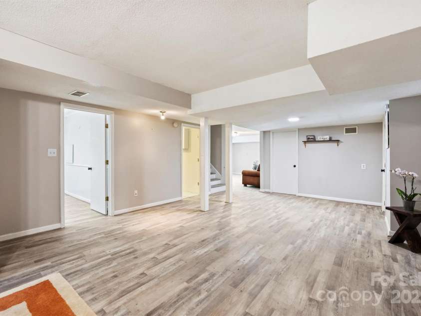 6150 Rocky Falls Road, Charlotte, NC 28211.  MLS# CAR4270630, YatesRealty ID 22677. Expansive basement offers ample living area and access to a storage/workshop area and an attached 1-car garage.