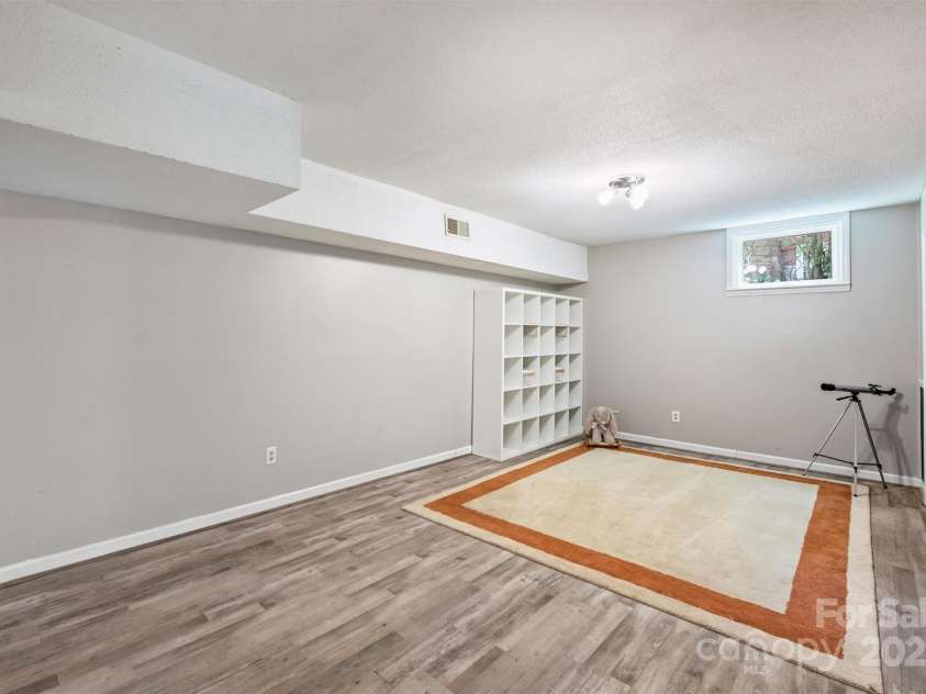 6150 Rocky Falls Road, Charlotte, NC 28211.  MLS# CAR4270630, YatesRealty ID 22677. Playroom/bonus room area in basement.