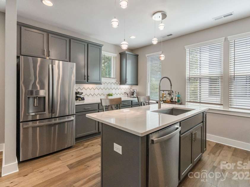2969 Simpson Drive, Charlotte, NC 28205.  MLS# CAR4270253, YatesRealty ID 22679. Kitchen with Quartz countertops, SS appliances, tile backsplash, and island