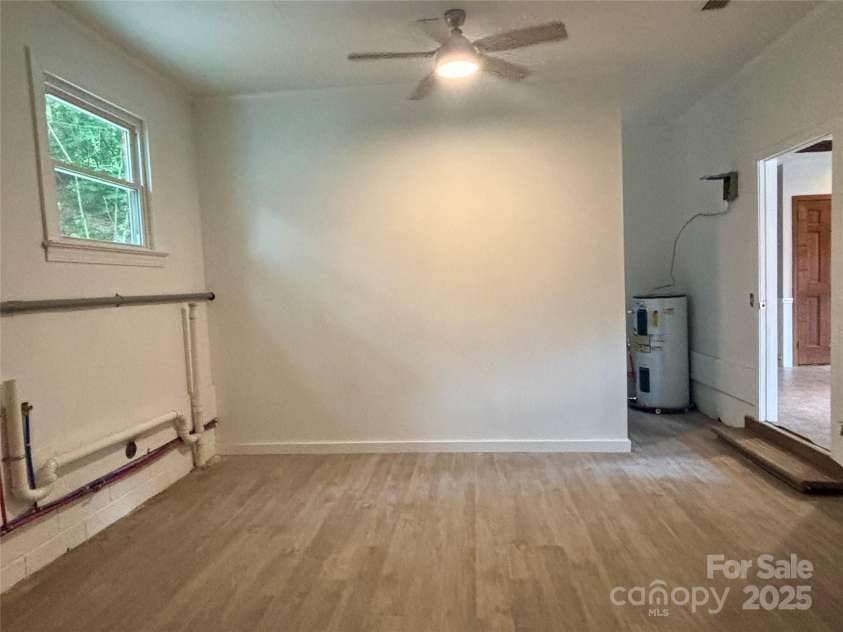 2130 Vashti Road, Taylorsville, NC 28681.  MLS# CAR4263613, YatesRealty ID 22689. Large heated/cooled laundry room with storage shelves.