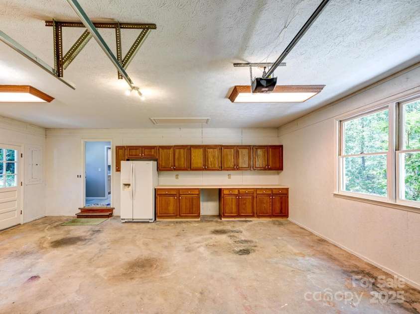 210 Fernwood Drive, Hendersonville, NC 28791.  MLS# CAR4275112, YatesRealty ID 22697. Garage with 2nd Frig and Work Space